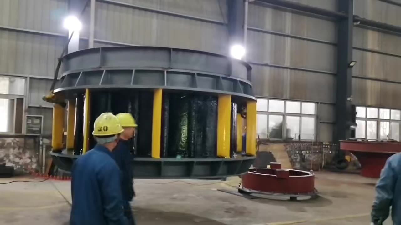 Workers assembling a large generator rotor rim — TC factory