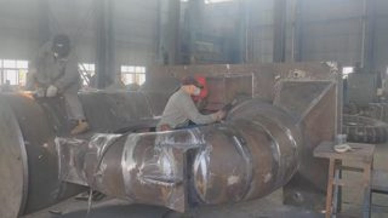 Certified welder fabricating large steel structure — TC factory